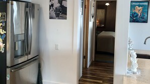 A modern kitchen with a stainless steel refrigerator, a water dispenser, and a patterned rug. - Lake front chalet-incredible view, sleeps 12! (Homewood)