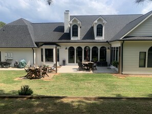 A two-story house with a covered patio, a barbecue area, and a well-maintained lawn. - SOUTHERN LIVING! Newly renovated! Private with Mountain views-sleeps 16 (Kingston)