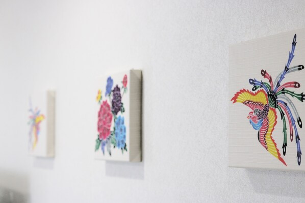 A series of artworks on a white wall.