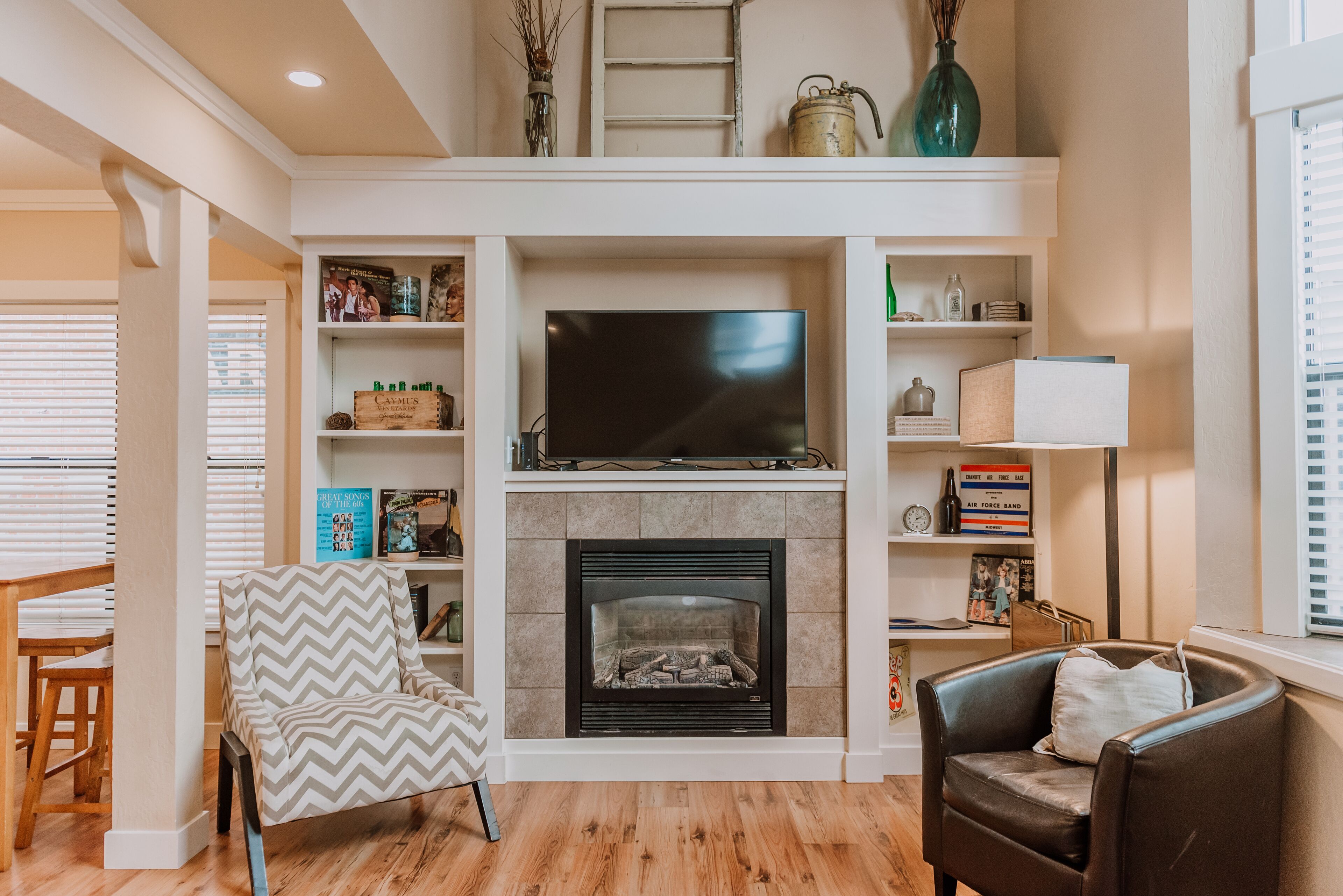 A living room with a fireplace, a television, and a bookshelf.