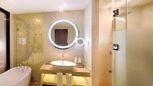 A modern bathroom with a freestanding bathtub, a round mirror with a light, and a vanity with a sink and towel rack. - Lavande Hotel - Guangzhou Panyu Chimelong (Guangzhou)