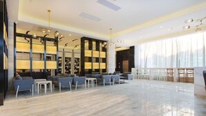 A spacious lobby with a marble floor, modern seating, and a large window with sheer curtains. - Lavande Hotel - Guangzhou Panyu Chimelong (Guangzhou)
