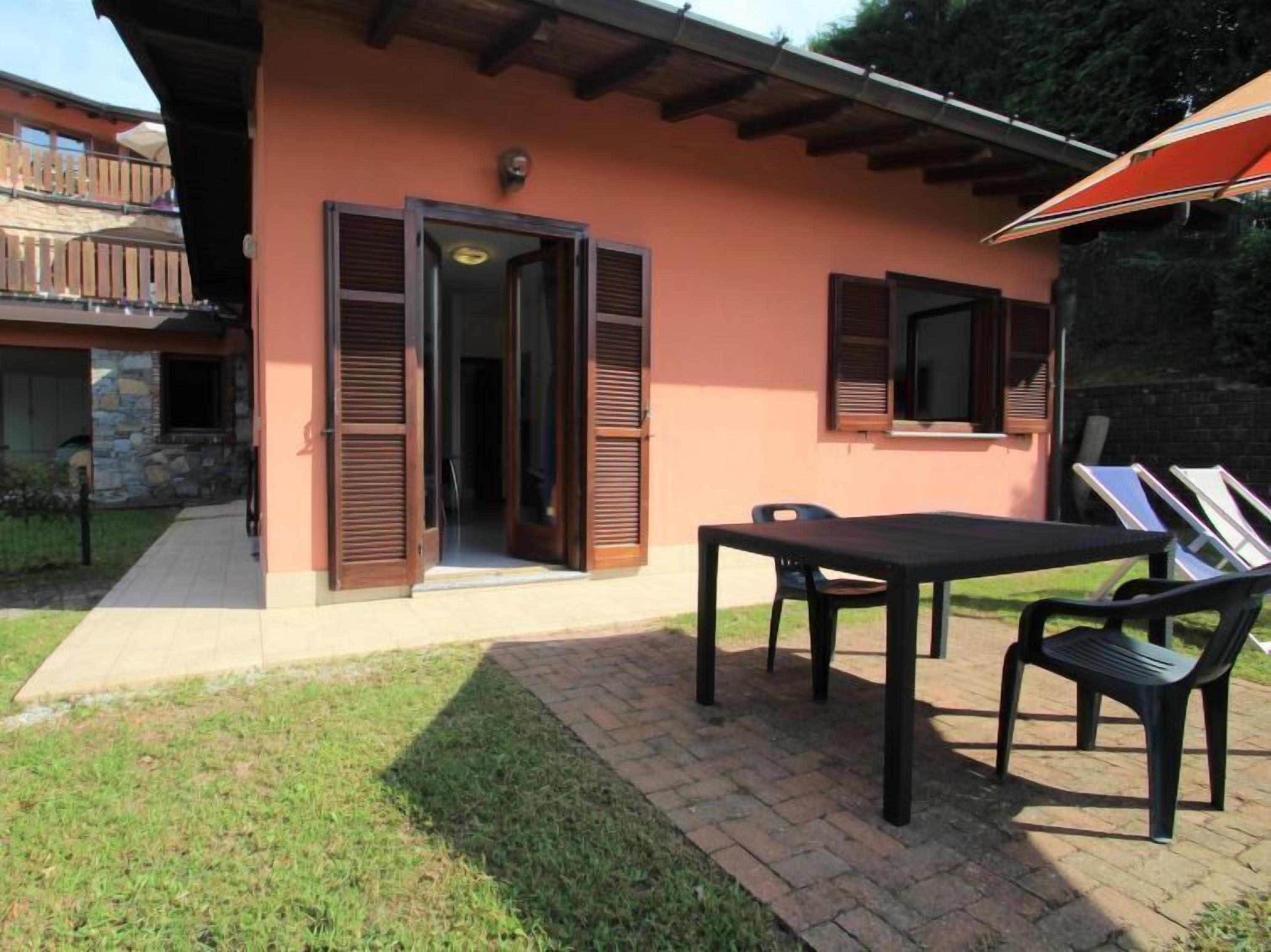 A house with a patio, a table, and chairs.
