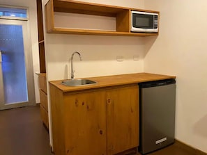 Fridge, microwave, coffee/tea maker, cookware/dishes/utensils