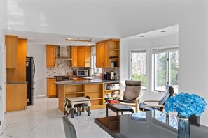 Enjoy casual dining and ample workspace in this kitchen with a central island and dining table.