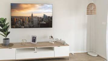 Basic Apartment, 4 Bedrooms | Living area | Flat-screen TV, Netflix, DVD player, streaming services