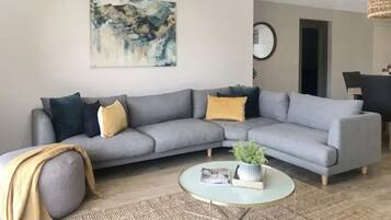 Basic Apartment, 4 Bedrooms | Living room | Flat-screen TV, Netflix, DVD player, streaming services