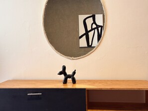 A room with a wooden desk, a black drawer, and a framed abstract artwork on the wall. - Spacious 8-bedroom House in Central Guadalajara (Guadalajara)