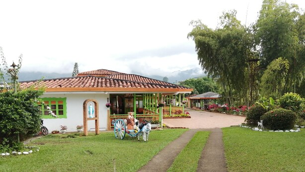 A house with a tiled roof, a porch, and a pathway leading to it. - Room-room With 2 Double Beds Number 4 (Pereira)