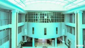 A spacious atrium with a high ceiling and a glass ceiling, featuring multiple levels and a central staircase. - Best Western Plus Mydas Hotel (Owo)