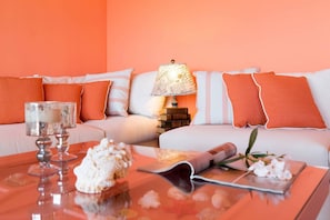 Un salon chaleureux avec un canapé, une lampe, une table basse et des objets de décoration.
