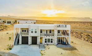 A modern two-story building with a flat roof, a staircase, and a balcony. - Lake View Modern House with Beautiful Sunsets! (Page)
