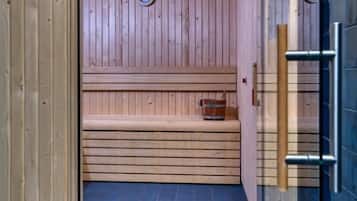 A sauna with wooden benches and a tiled floor.