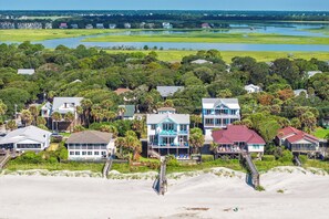 A coastal residential area with houses, a beach, and a water body. - Exquisite Oceanfront Oasis: Immerse in Luxury with Pool & Putting Green! (Folly Beach)