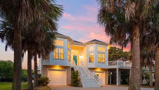 A two-story house with a front entrance, a covered porch, and a staircase leading to the upper level. - Elegant, Luxury Home w/Private Pool & Easy Beach Access-North Myrtle Beach Rental (North Myrtle Beach)