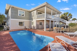 A two-story house with a swimming pool, outdoor seating, and a covered patio. - Immaculate Oceanfront Home - Completely Renovated, Private Pool, Game Room - in Ocean Drive (North Myrtle Beach)