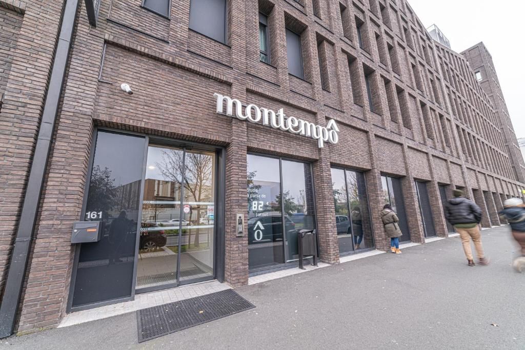 A modern building with a sign reading 'montempo' and a visible entrance.