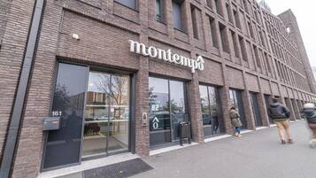 A modern building with a sign reading 'montempo' and a visible entrance.