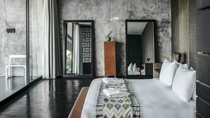 A modern bedroom with a large bed, a mirror, and a view of the outdoors. - Villa Mana by Elite Havens (Canggu)