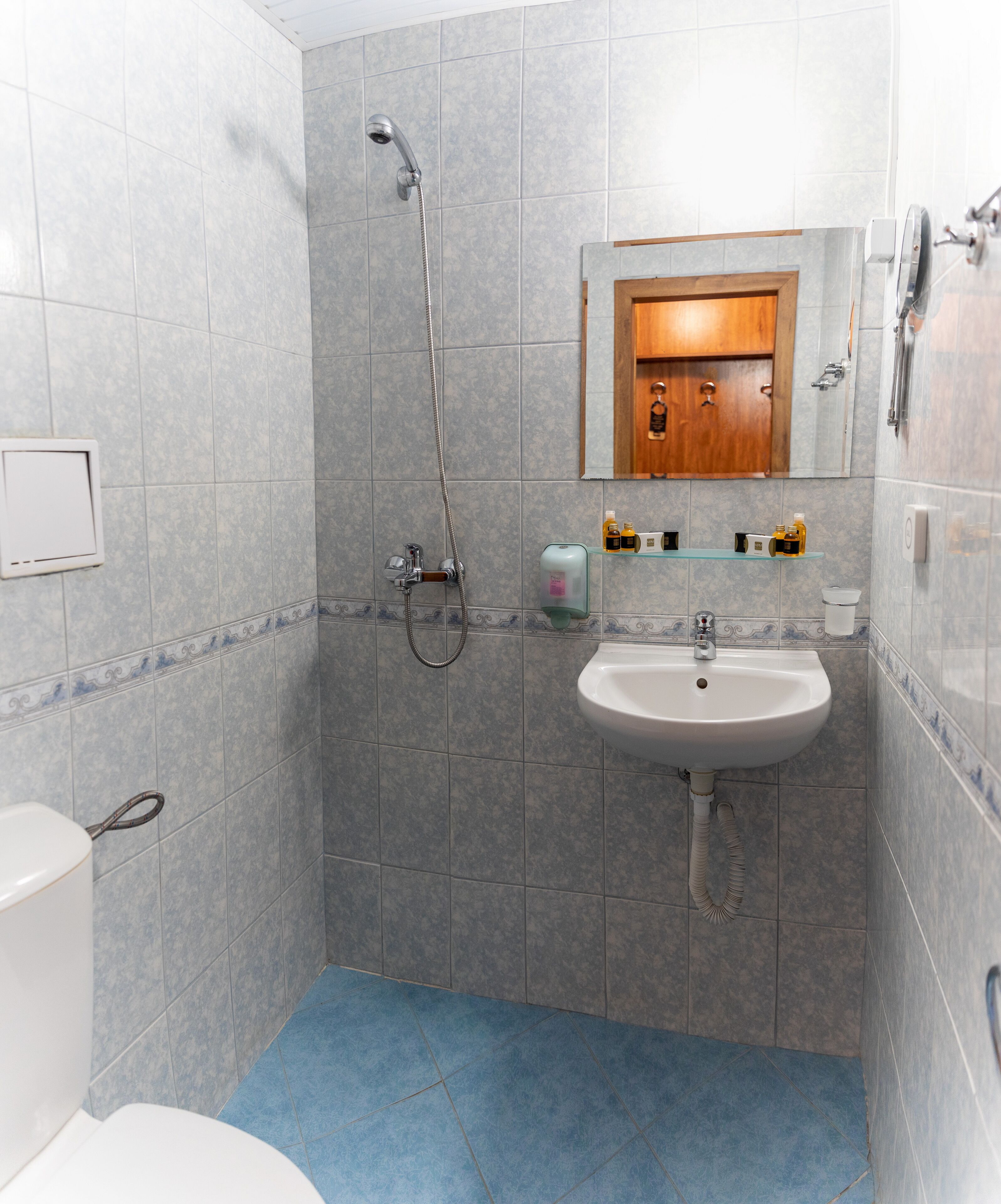 Ein Badezimmer mit Dusche, Waschbecken und Toilette.