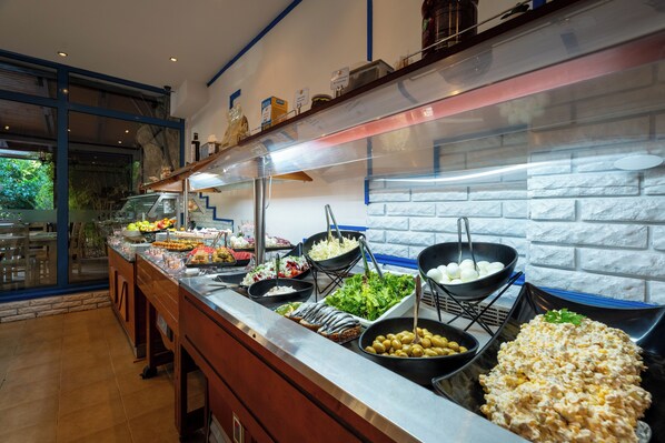 A buffet with various food items and a view of the outdoors. - MPM Hotel Condor - All Inclusive Light (Sunny Beach)