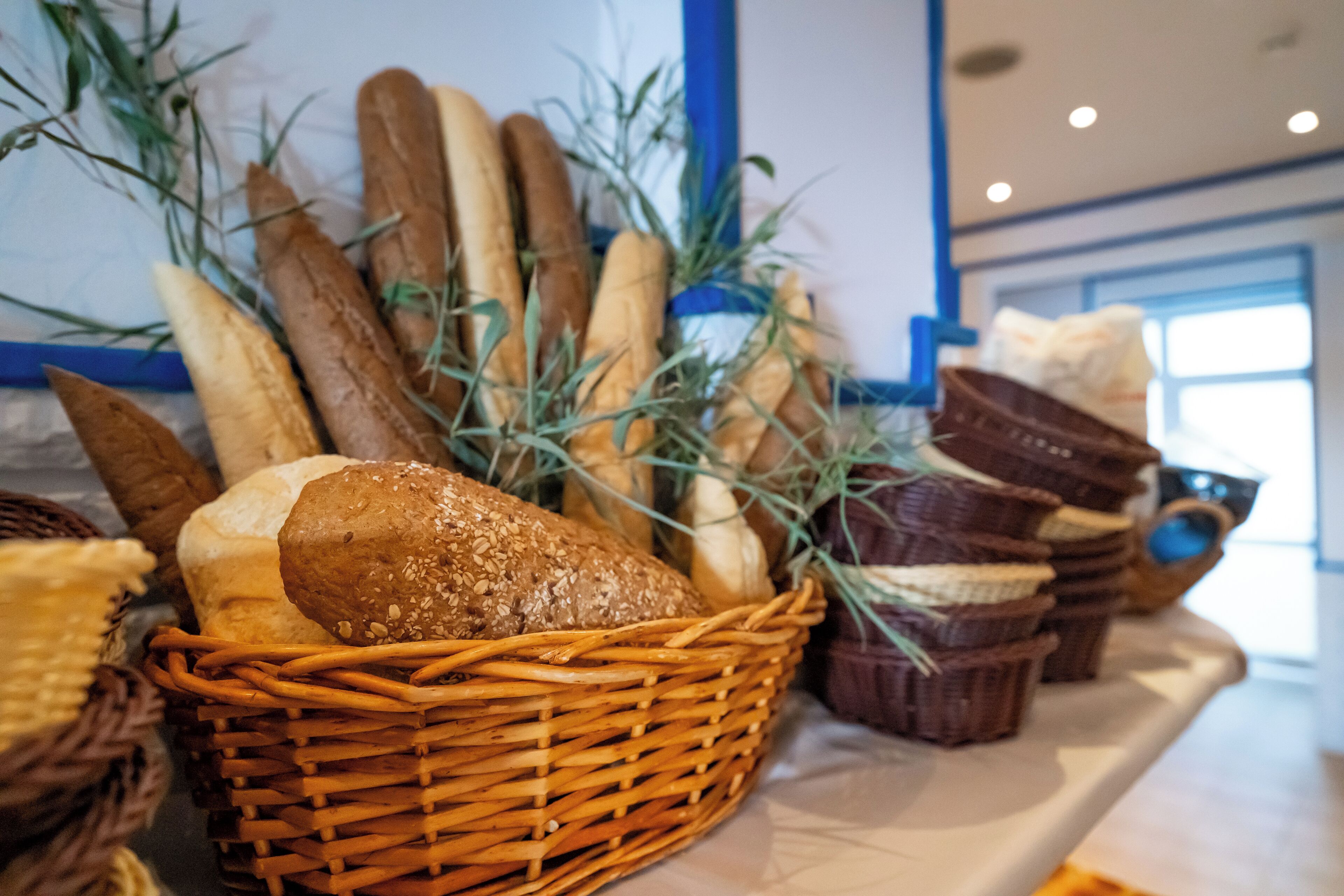 A variety of breads and pastries displayed on a counter.