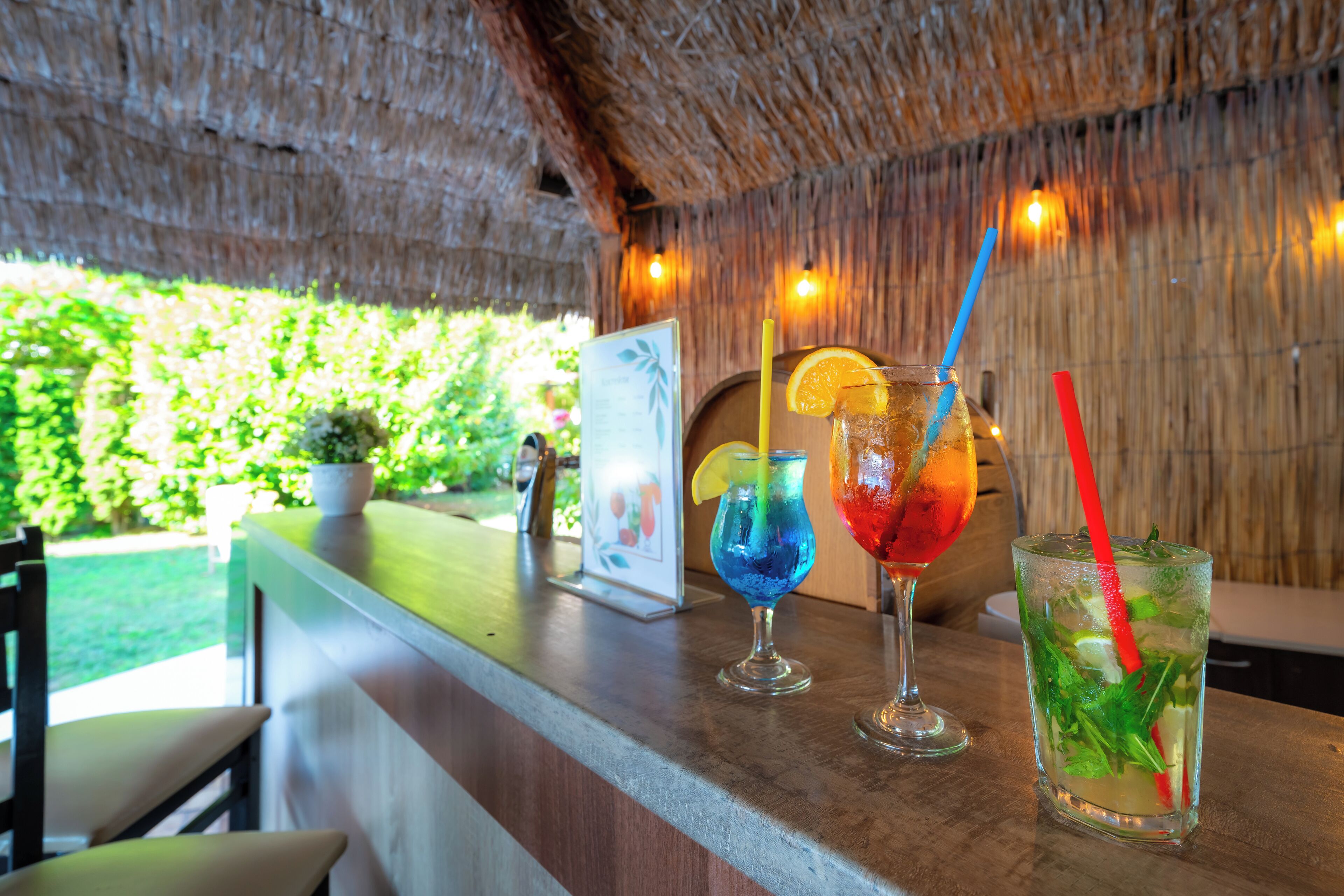 A bar area with drinks and a menu sign.