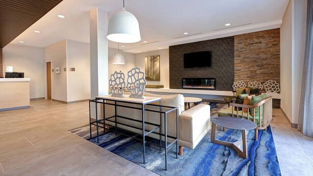 A modern living room with a sofa, coffee table, and a fireplace. - Fairfield Inn & Suites by Marriott St. Paul Eagan (Eagan)