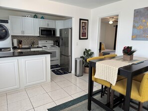 Enjoy cooking in this well-equipped kitchen with stainless steel appliances, a central island, and a dining area.