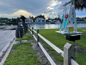 Enjoy waterfront views from this house with a dock and lawn.