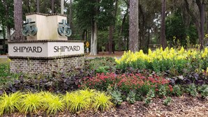 A sign with 'SHIPYARD' written on it, surrounded by a garden with various plants and flowers. - Wildlife Watching! Lagoon & Golf view, beach gear included. Peaceful & Private! (Hilton Head Island)