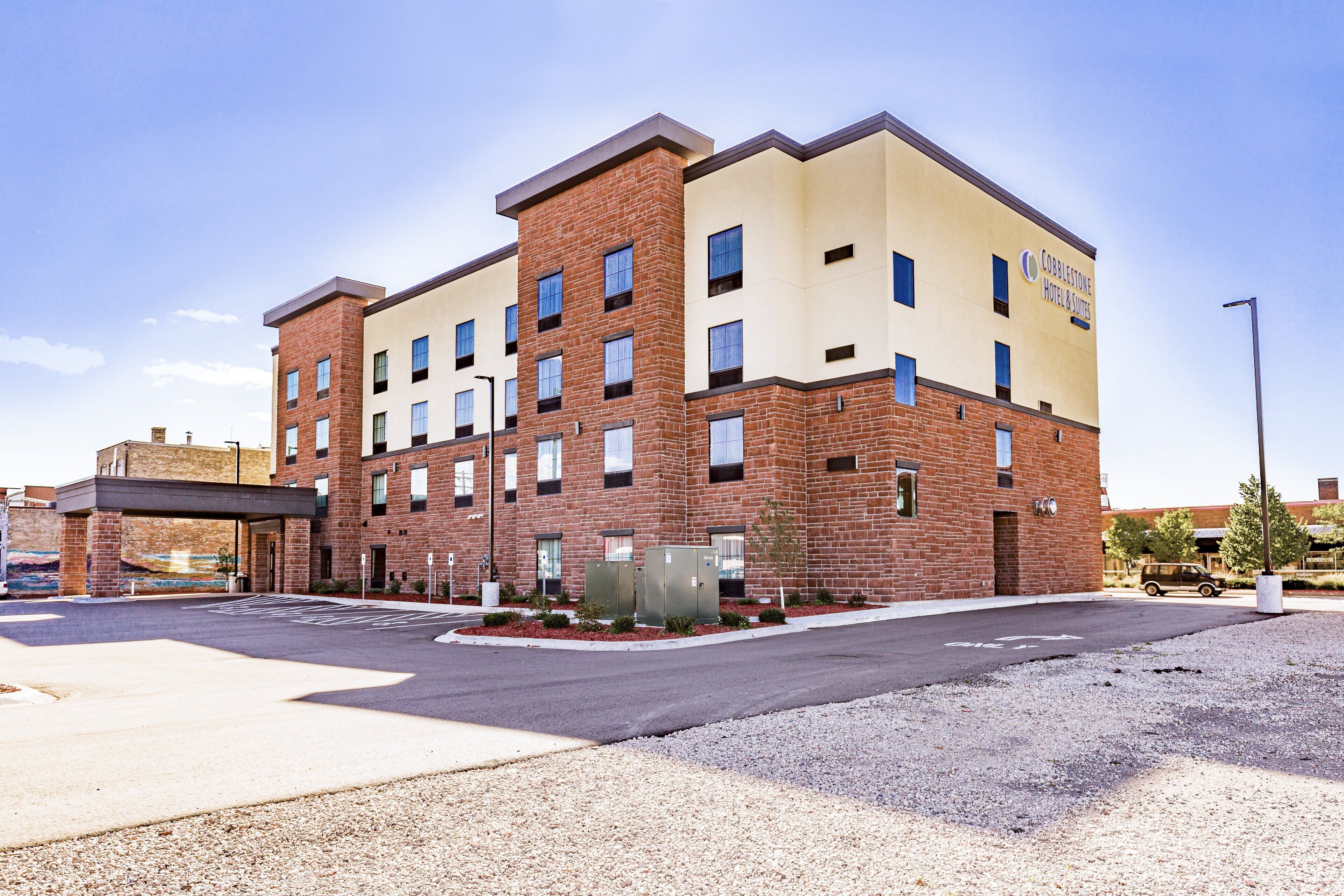 A multi-story hotel with a brick facade and a flat roof.