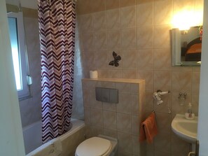 Bathtub, hair dryer, towels