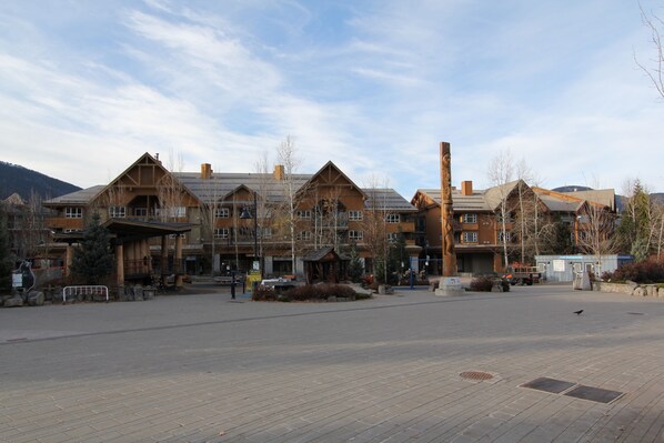 A lodge with a central courtyard, wooden exterior, and multiple buildings with pitched roofs.