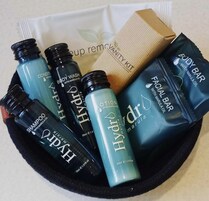 A collection of skincare products including shampoo, body wash, lotion, and facial bar, all labeled with 'with marula oil'.