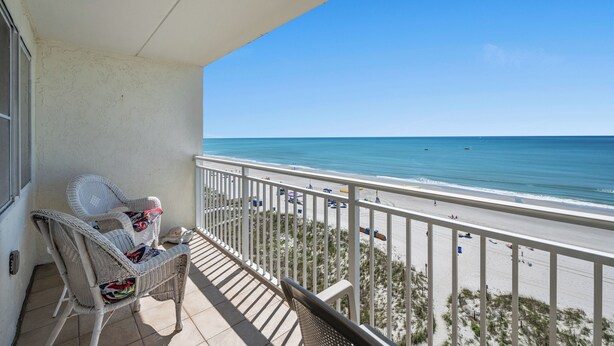 A balcony with wicker chairs overlooking a beach. - Oceanfront Condo, Sanabel 505: 2BR 2BA with Outdoor Hot tub (North Myrtle Beach)