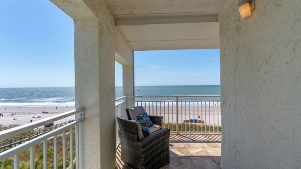 A balcony with wicker furniture and a view of the beach and ocean. - Sanabel 215, Extraordinary Views from Extra Large Oceanfront Balcony (North Myrtle Beach)
