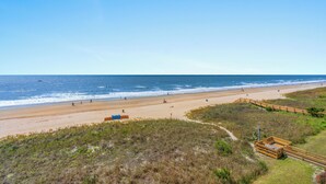 A beach with a wooden boardwalk, sandy beach, and ocean view. - Sanabel 215, Extraordinary Views from Extra Large Oceanfront Balcony (North Myrtle Beach)