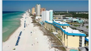 A coastal hotel with a beach view, multiple floors, and a swimming pool. - Let it BEach - Beach Property (Panama City Beach)