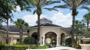 A hotel entrance with a sign reading "Windsor Hills Clubhouse." - Magical Location Condo Close to Clubhouse & Pool - Windsor Hill Resort (Kissimmee)