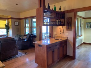 A kitchen with wooden cabinets, a marble countertop, and a built-in sink. - New True Country Craftsman (Eugene)