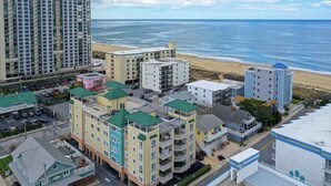 A coastal hotel complex with multiple buildings, including a large multi-story hotel and several smaller structures.