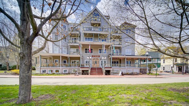 A multi-story building with a central entrance, balconies, and a sign reading "St. Elmo". - Experience Chautauqua! Newly Renovated Studio (Chautauqua)