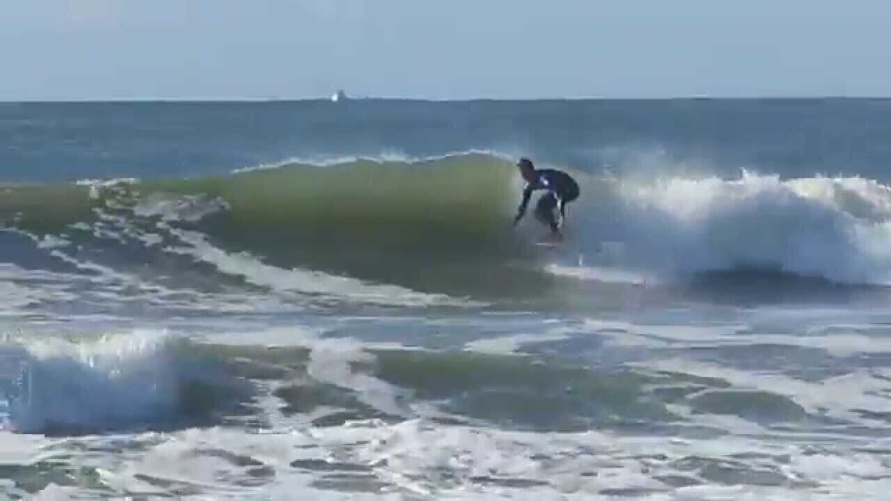 A surfer riding a wave in the ocean.