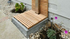 A modern outdoor entrance with a wooden slatted door and a concrete base. - Luxury Cardiff By-the-sea Ocean View Parkhouse (Cardiff-by-the-Sea)