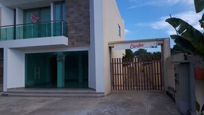 Caribe building features a contemporary entrance with a wooden fence.