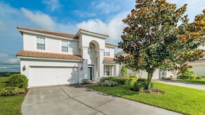 A two-story house with a white exterior, a red-tiled roof, and a garage. - Beautiful 5 Star Villa with Private Pool on the Prestigious Windsor Hills Resort, Orlando Villa 4773 (Orlando)