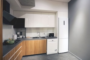 Enjoy cooking in this well-equipped kitchen with sleek cabinetry, a stainless steel sink, and dishwasher.