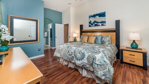 A bedroom with a large bed, a nightstand, a dresser, and a mirror. - Exclusive 5 Star Villa with Private Pool on Windsor Palms Resort, Orlando Villa 4882 (Orlando)