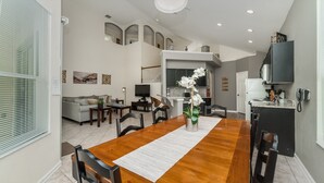 A modern living space with a dining area, kitchen, and seating area. - Exclusive 5 Star Villa with Private Pool on Windsor Palms Resort, Orlando Villa 4903 (Orlando)